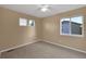 Bedroom with neutral walls, neutral carpet and two windows for natural light at 2587 S Flanders Ct, Aurora, CO 80013