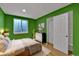 Bright bedroom featuring colorful walls, a comfortable bed, and sliding door closet at 2587 S Flanders Ct, Aurora, CO 80013