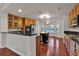 Bright kitchen features wood cabinets, granite countertops and stainless steel appliances at 2587 S Flanders Ct, Aurora, CO 80013