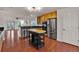 Open kitchen featuring stainless steel appliances, a center island, and hardwood floors, ideal for cooking at 2587 S Flanders Ct, Aurora, CO 80013