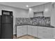 Basement kitchenette features grey cabinets, granite countertops and stylish backsplash at 2587 S Flanders Ct, Aurora, CO 80013