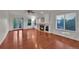 Bright living room with gleaming hardwood floors, a cozy fireplace, and French doors to the outdoor at 2587 S Flanders Ct, Aurora, CO 80013