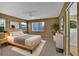 Comfortable main bedroom featuring a ceiling fan, windows, and carpet floor at 2587 S Flanders Ct, Aurora, CO 80013