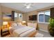Cozy main bedroom with warm colors, a modern bed set, and a flat screen TV at 2587 S Flanders Ct, Aurora, CO 80013
