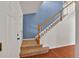 Staircase with wood railing and carpet runner at 2587 S Flanders Ct, Aurora, CO 80013
