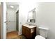 Bathroom featuring vanity with sink, tile floor, standing shower stall, and toilet at 6376 Lamar Pl, Arvada, CO 80003
