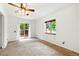Bright bedroom featuring a ceiling fan, carpet, and sliding glass doors to the backyard at 6376 Lamar Pl, Arvada, CO 80003