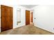 Carpeted bedroom with closet, and easy access to the hallway at 6376 Lamar Pl, Arvada, CO 80003