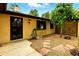 Charming courtyard area with low-maintenance gravel, flagstone path, and a secure iron gate at 6376 Lamar Pl, Arvada, CO 80003