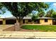 Charming single-story home featuring a well-manicured lawn, mature trees and an attached two car garage at 6376 Lamar Pl, Arvada, CO 80003