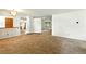 Spacious living room featuring plush carpeting and open floor plan to the kitchen and dining area at 6376 Lamar Pl, Arvada, CO 80003