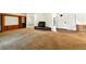 Spacious living room featuring a pellet stove fireplace, built in shelves, and open floor plan at 6376 Lamar Pl, Arvada, CO 80003