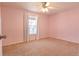 Cozy bedroom with pink walls, carpet floor, and window perfect for creating a tranquil and personalized space at 12114 Melody Dr # 303, Denver, CO 80234