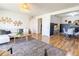 Bright living room with hardwood floors seamlessly transitions into the dining area at 12114 Melody Dr # 303, Denver, CO 80234