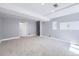 Bright basement with gray carpet, a utility closet, and a door to a storage area at 3734 Licorice Trl, Castle Rock, CO 80109
