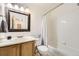 Cozy bathroom with a shower-tub combo and classic vanity with wood cabinets at 3734 Licorice Trl, Castle Rock, CO 80109