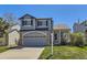 Charming two-story home with a well-manicured lawn, attached garage, and inviting front porch at 3734 Licorice Trl, Castle Rock, CO 80109