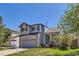 Charming two-story home with a well-manicured lawn, attached garage, and inviting front porch at 3734 Licorice Trl, Castle Rock, CO 80109