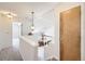 Bright hallway with an open view of the kitchen and stairwell, light gray carpet, and fresh white walls at 3734 Licorice Trl, Castle Rock, CO 80109