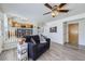 Inviting living room with stylish decor, modern ceiling fan, and light wood-look flooring at 3734 Licorice Trl, Castle Rock, CO 80109