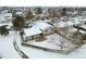 Aerial view of house and yard in snowy neighborhood at 15895 E 17Th Pl, Aurora, CO 80011