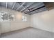 Unfinished basement with exposed ceiling beams and carpet at 15895 E 17Th Pl, Aurora, CO 80011