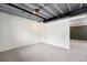 Unfinished basement with exposed ceiling beams and carpet at 15895 E 17Th Pl, Aurora, CO 80011