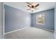 Simple bedroom with light gray walls, ceiling fan and carpet at 15895 E 17Th Pl, Aurora, CO 80011