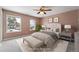 Virtually staged main bedroom with plush bed and neutral color palette at 15895 E 17Th Pl, Aurora, CO 80011