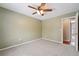 Neutral bedroom with ceiling fan and doorway leading to another room, carpeted throughout at 15895 E 17Th Pl, Aurora, CO 80011