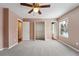 Bright bedroom with two windows, ceiling fan, and ample closet space at 15895 E 17Th Pl, Aurora, CO 80011