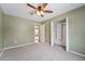 Simple bedroom with light green walls, ceiling fan and carpet at 15895 E 17Th Pl, Aurora, CO 80011