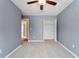 Simple bedroom with light blue walls, ceiling fan and carpet at 15895 E 17Th Pl, Aurora, CO 80011