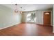 Dining room with wood floors, large window, and view of front yard at 15895 E 17Th Pl, Aurora, CO 80011