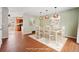 Virtually staged dining room featuring a wood table and modern light fixtures at 15895 E 17Th Pl, Aurora, CO 80011