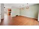 Bright dining room with wood flooring and view into kitchen area at 15895 E 17Th Pl, Aurora, CO 80011