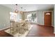 Virtually staged dining area with wood floors and view of the front yard at 15895 E 17Th Pl, Aurora, CO 80011