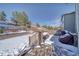 Spacious backyard with deck, retaining walls, and snowy landscape at 2959 Skyward Way, Castle Rock, CO 80109