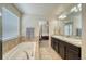 Main bathroom with double vanity and access to bedroom at 2959 Skyward Way, Castle Rock, CO 80109