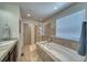 Bathroom with soaking tub, shower, and double sinks at 2959 Skyward Way, Castle Rock, CO 80109