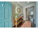 Inviting entryway with teal door, console table, and decorative mirror at 2959 Skyward Way, Castle Rock, CO 80109