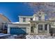 Two-story house with a teal garage door and a covered porch, snow on the ground at 2959 Skyward Way, Castle Rock, CO 80109