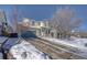 Two-story house with a driveway, surrounded by snow-covered trees at 2959 Skyward Way, Castle Rock, CO 80109