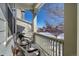 Covered porch with wicker chairs overlooking a snowy neighborhood at 2959 Skyward Way, Castle Rock, CO 80109