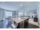 Kitchen island with granite countertops, stainless steel appliances, and dark cabinets at 2959 Skyward Way, Castle Rock, CO 80109