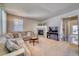 Spacious living room featuring a cozy fireplace and ample natural light at 2959 Skyward Way, Castle Rock, CO 80109