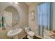 Small powder room with pedestal sink, toilet and decorative accents at 2959 Skyward Way, Castle Rock, CO 80109