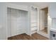 Bright white closet with built-in shelves and hanging rod at 4324 Eaton St, Denver, CO 80212