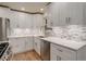 Modern kitchen with white cabinets, quartz countertops, and tile backsplash at 4324 Eaton St, Denver, CO 80212