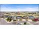 Charming neighborhood view showcasing lush green spaces and well-maintained homes under a blue sky at 5049 Heatherglen Dr, Highlands Ranch, CO 80130